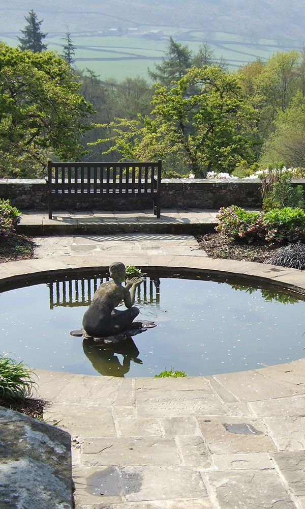 A geometric garden with a central circular pond looks out over a Yorkshire landscape.