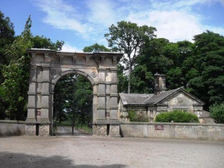 Stone arched gateway with lodge house adjacent