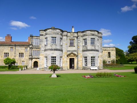 South front of Newburgh Priory showing elevation of stone building and grassed lawns in front
