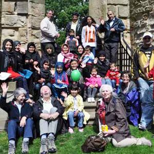 A group of adults and children at a garden visit.