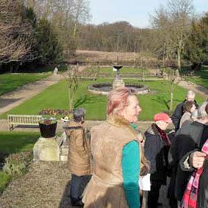 People descend stairs during a garden visit.