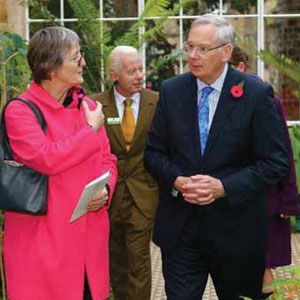 Two people talk during a function.