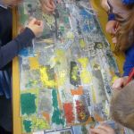 Schoolchildren work on creating a colourful collage.