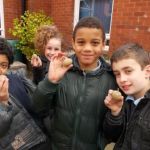 School children hold bulbs.