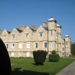 Ledston Hall view of house and yew topiary on grassed lawn to the side