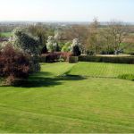 View of gardens looking across grassed lawns to the landscape beyond